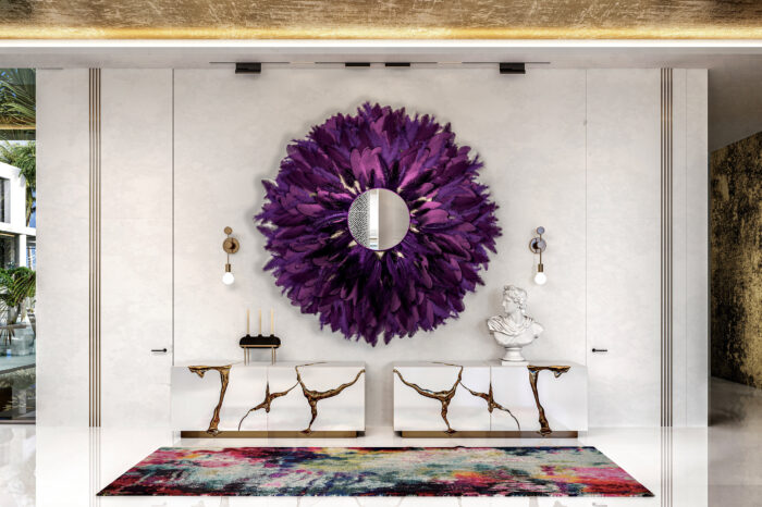 Purple feather mirror hangs above two Boca do Lobo cabinets